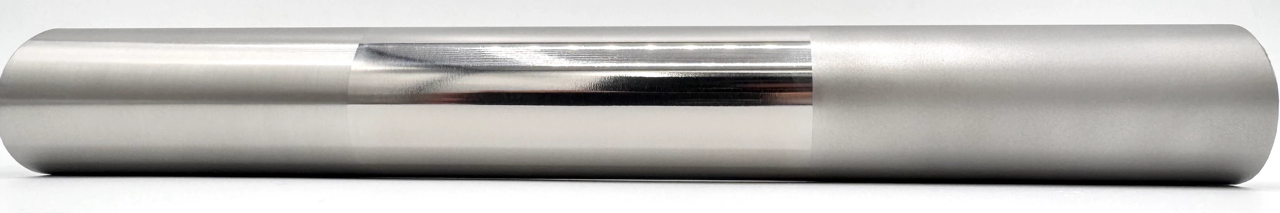 One titanium tube finished three ways: brushed on the left, mirror-polished through the middle, satin bead-blasted on the right.
