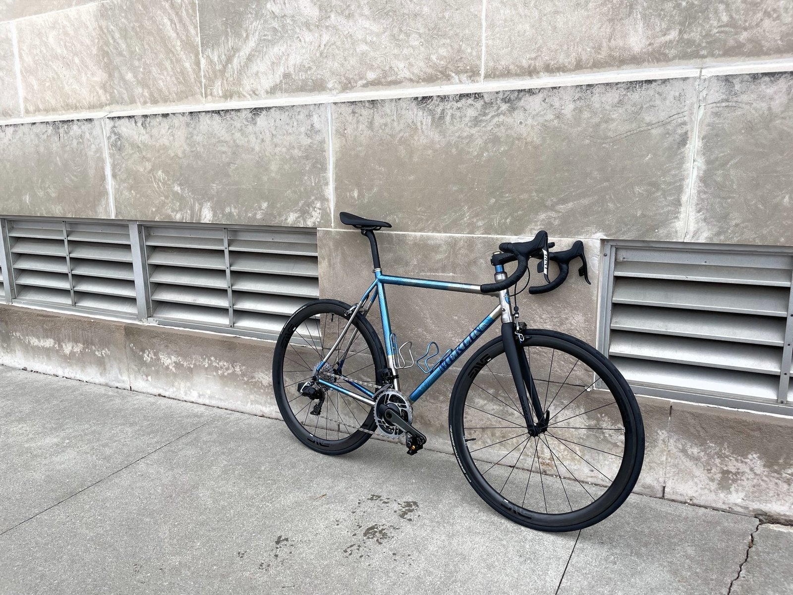 Moots titanium road bike with blue camouflage anodizing, built with ENVE wheels
