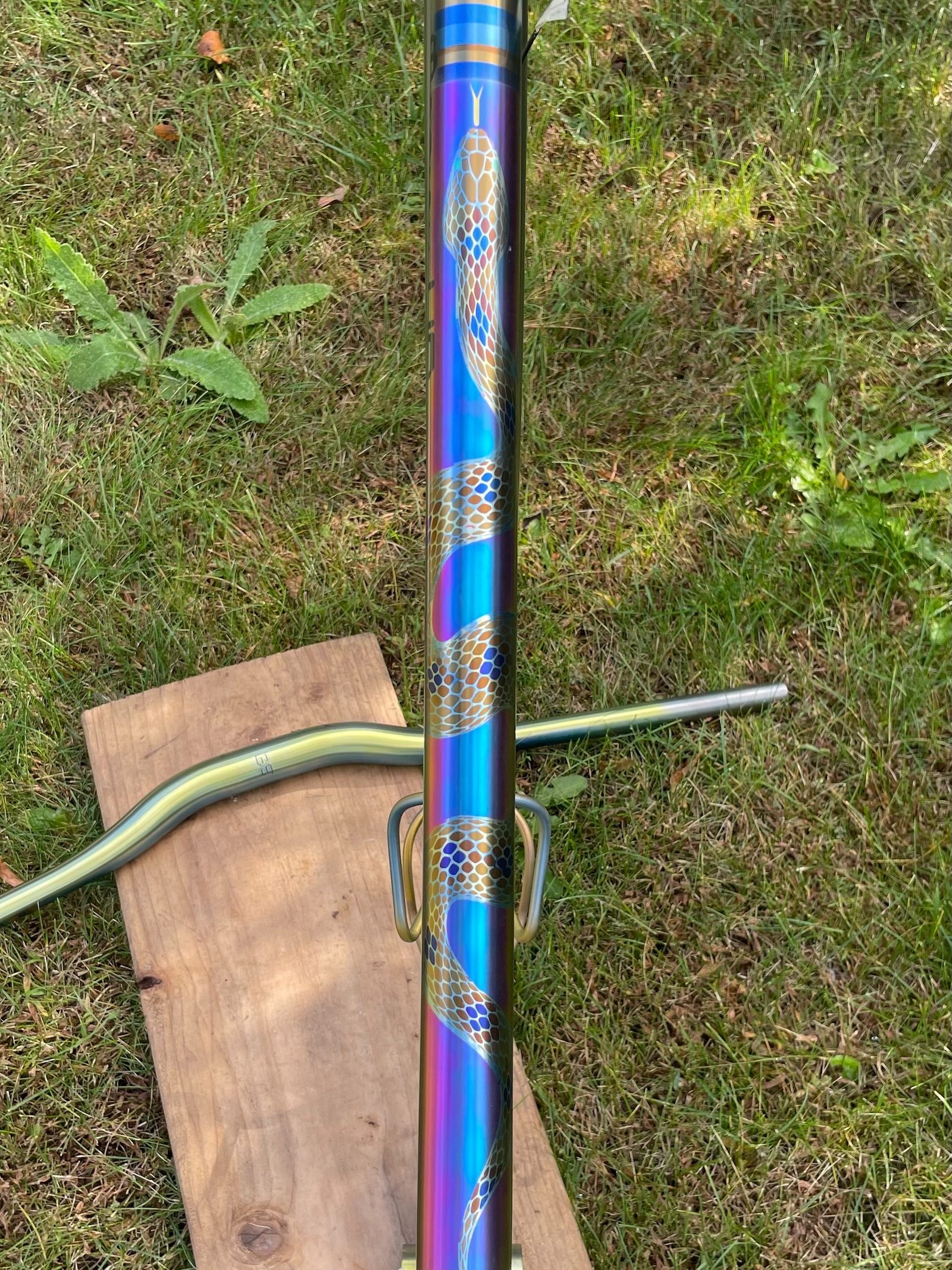Close-up of blue and gold pattern anodizing on a titanium tube