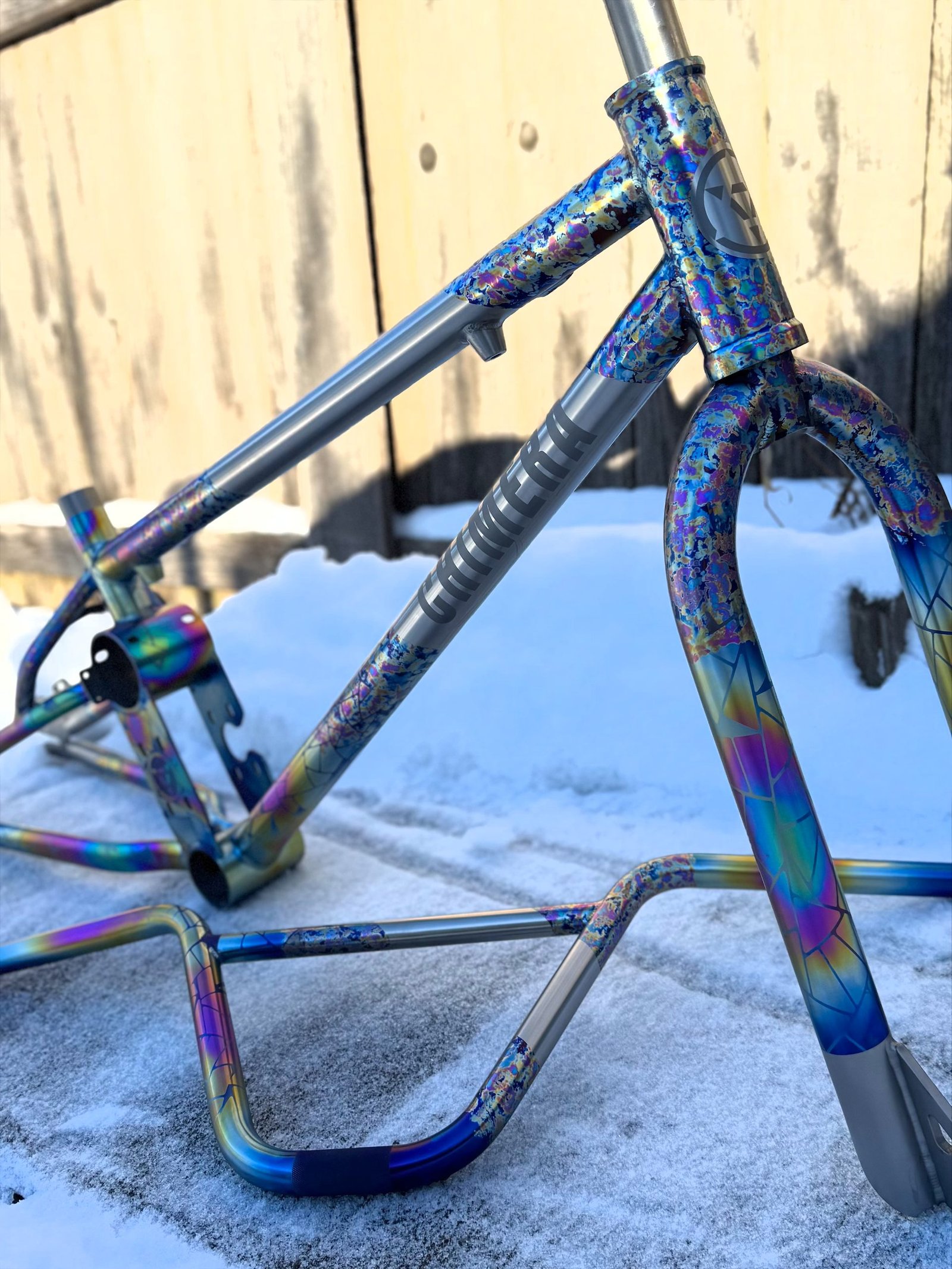 Speckle-anodized titanium frame photographed in snow